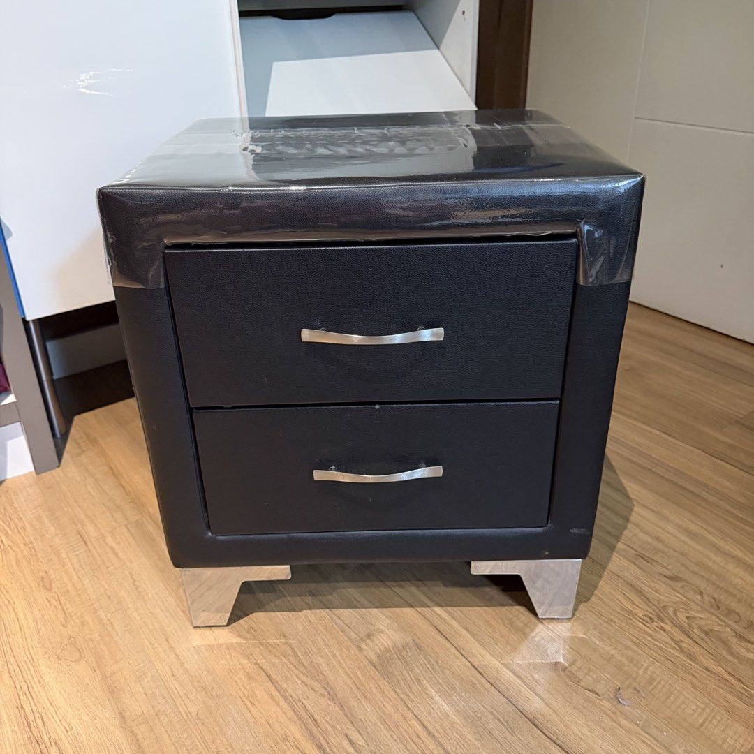 Black Faux Leather 2-Drawer Nightstand Bedside Table (Category: Shelves, Cabinets & Racks) located in Manila. Submitted by gminshie (Listing ID 1466043439, Image 2). Description: For Sale: 2x Bed Side Cabinet — 3k each. 48x40x54 Good as new. No issue. (Plastic cover on top can be removed. For dust purposes only. 😅).