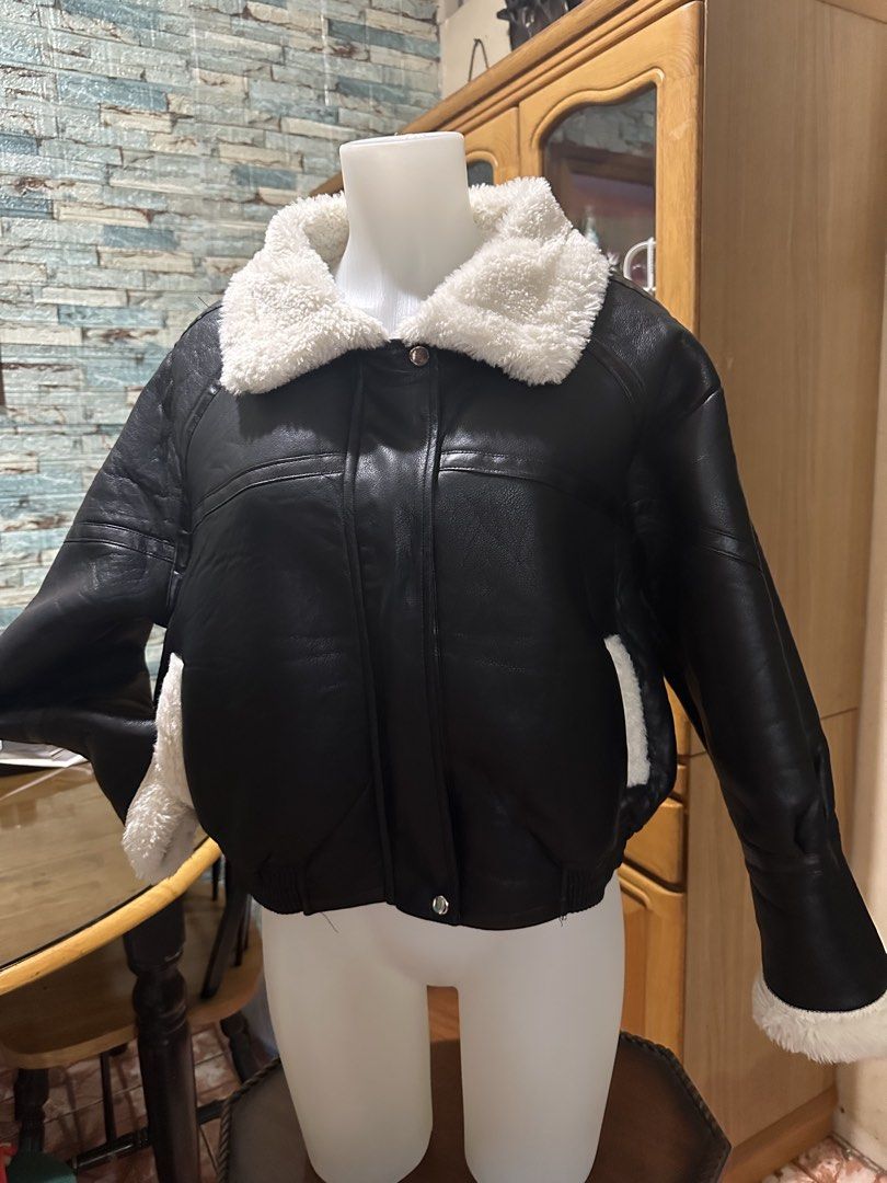 Black Faux Leather Shearling Bomber Jacket (Category: Coats, Jackets and Outerwear) located in Rizal. Submitted by shoppables (Listing ID 1465983083, Image 2). Description: - Style: Black faux leather bomber jacket with thick white sherpa collar, cuffs, and hem - Fit: Trendy boxy oversized fit - Warmth: Super warm, perfect for cold weather - Features: Full front zipper with top and bottom snap buttons, plus deep side pockets - Condition: Worn onl