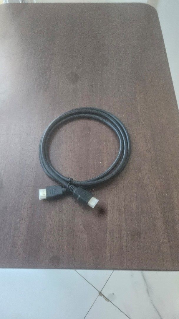 Black HDMI cable with protective caps (Category: Cables & Adaptors) located in Manila. Submitted by jessielevi777 (Listing ID 1465955430, Image 1). Description: - Standard black HDMI cable with connectors on both ends - Ideal for connecting monitors, gaming consoles, or TVs - Includes white protective caps to keep out dust - Clean cord that rolls up neatly for easy storage - Handy and useful spare cable to have at home.