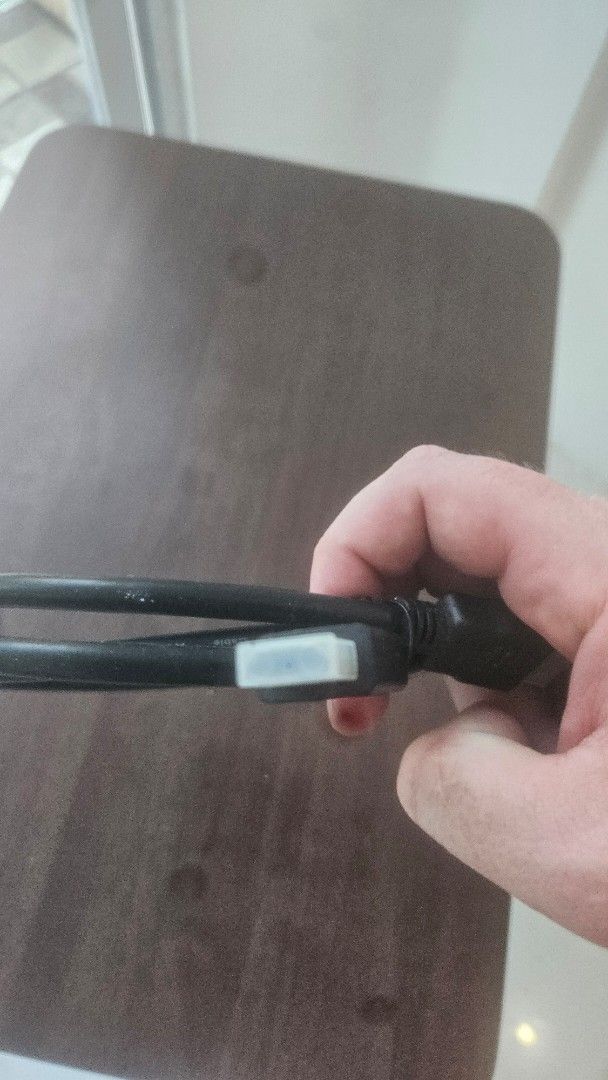 Black HDMI cable with protective caps (Category: Cables & Adaptors) located in Manila. Submitted by jessielevi777 (Listing ID 1465955430, Image 2). Description: - Standard black HDMI cable with connectors on both ends - Ideal for connecting monitors, gaming consoles, or TVs - Includes white protective caps to keep out dust - Clean cord that rolls up neatly for easy storage - Handy and useful spare cable to have at home.