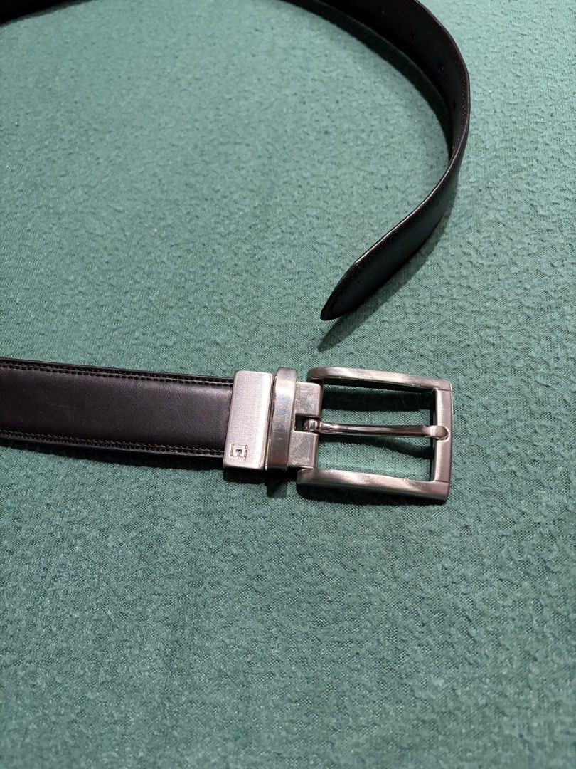 Black Leather Belt with Silver Buckle (Category: Belts) located in Guihulngan. Submitted by fbthriftgoodsniace (Listing ID 1465979169, Image 3). Description: Classic black leather belt with contrast stitching along the edges. Includes a rectangular silver-tone metal buckle featuring a small engraved logo detail. Clean strap with standard punch holes on the other end. Clean, minimalist daily wear accessory that goes well with casual or formal outf
