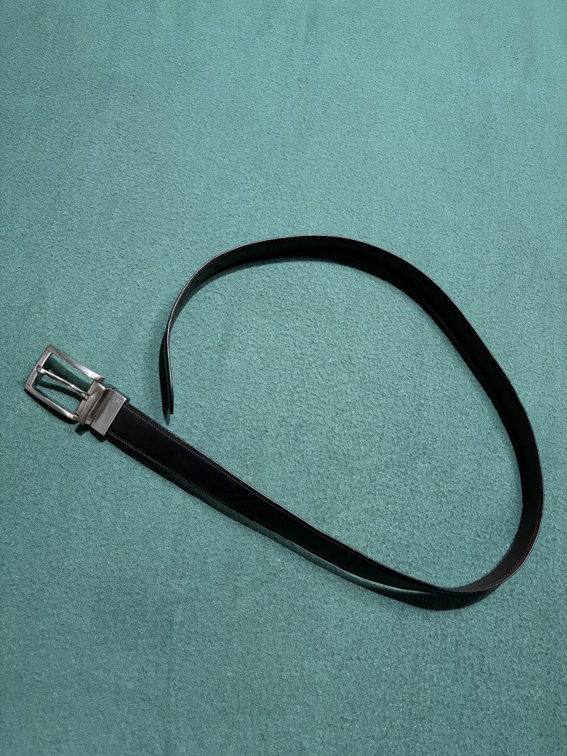Black Leather Belt with Silver Buckle (Category: Belts) located in Guihulngan. Submitted by fbthriftgoodsniace (Listing ID 1465979169, Image 1). Description: Classic black leather belt with contrast stitching along the edges. Includes a rectangular silver-tone metal buckle featuring a small engraved logo detail. Clean strap with standard punch holes on the other end. Clean, minimalist daily wear accessory that goes well with casual or formal outf
