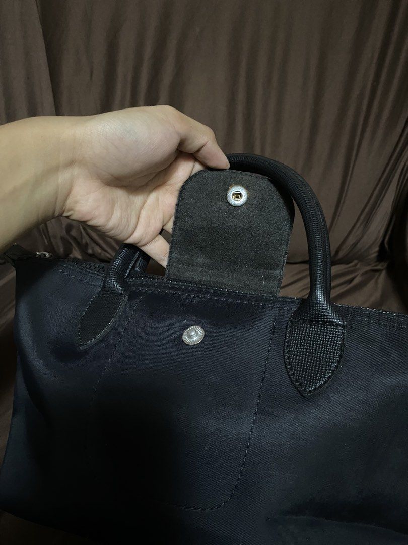 Black Long Champ Handbag (Category: Shoulder Bags) located in Dagupan City. Submitted by maryennie (Listing ID 1466063852, Image 3). Description: Working zippers (all) Spacious interior Suitable for work, daily use or travel -Condition: Pre-loved, with visible signs of use such surface scratches/scuffs and some wear on the silver hardware. Please refer to photos for exact condition. ⭐️Selling as-is. Please inspect photos carefully before purchasi