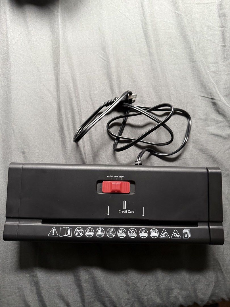 Black Portable Strip-Cut Paper Shredder with Extendable Arm (Category: Office & Business Technology) located in Taguig. Submitted by ajiichaban (Listing ID 1465974030, Image 1). Description: - Type: Compact black strip-cut shredder - Capacity: Shreds up to 6 sheets of paper and credit cards at once - Design: Features an extendable arm to fit over most bins - Controls: Top switch with Auto, Off, and Rev settings - Condition: Clean and works great,
