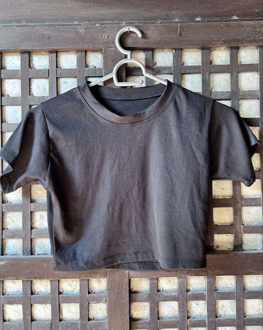 Black ribbed short sleeve crop top (Category: Shirts) located in Makati City. Submitted by hzsans92 (Listing ID 1466104907, Image 1). Description: - Color: Classic Black - Style: Cropped top with short sleeves and crew neckline - Material: Textured ribbed fabric - Fit: Fitted cut with clean hem and stitched edges - Versatility: Easy to style with high-waisted jeans or skirts, ideal for everyday wear.