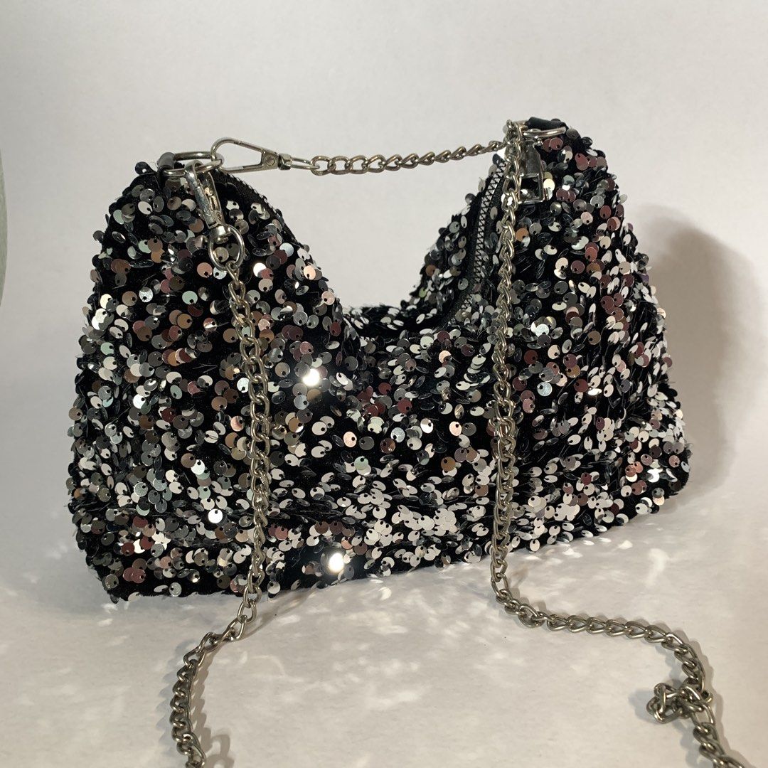 Black sequin shoulder bag with silver chain (Category: Shoulder Bags) located in Rizal. Submitted by shop_ms.lai (Listing ID 1465953775, Image 3). Description: - Sparkling black and silver sequin design - Secure zip-top closure - Includes a removable silver metal chain strap - Compact size (fits phones and cards easily) - Perfect for parties and nights out.