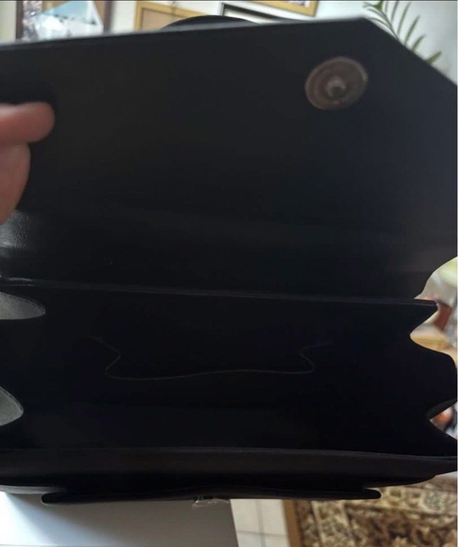 Black structured handbag with top handle and magnetic closure (Category: Tote Bags) located in Taguig. Submitted by macxdinglas (Listing ID 1465992989, Image 2). Description: - Classic black handbag with a sleek, structured design - Secure flap front with magnetic snap closure - Single top handle for effortless carrying - Multiple interior compartments for easy organization - Clean fabric lining throughout - Versatile size and style for daily use