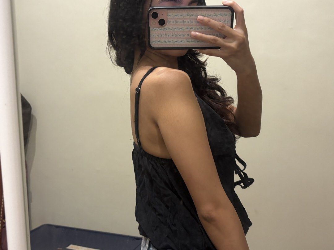 Black tie front cami tank linen top (Category: Sleeveless) located in Paranaque City. Submitted by domisclosett (Listing ID 1466089568, Image 3). Description: - Color: Black - Style: Cami top with thin straps and V-neckline - Details: Multiple tie-front bows down the center chest - Fabric: Lightweight, perfect for warm weather or layering - Condition: Worn a few times, still in great shape loc: parañaque/muntinlupa area mop: gcash, maribank, goty