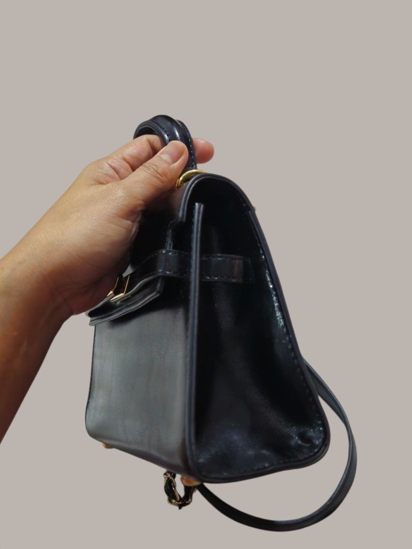 Mini Kelly Top handle Bag with Sling (Category: Shoulder Bags) located in Caloocan City. Submitted by zoetormojal.18d615 (Listing ID 1466027522, Image 3). Description: Cute Mini kelly bag - Top handle - Detachable chain strap - Gold clasp closure - Versatile - Great for nights out or casual outings - H 6" x L 8" x D 3" Inches - NO Issue all intact like new condition - Pickup is welcome.