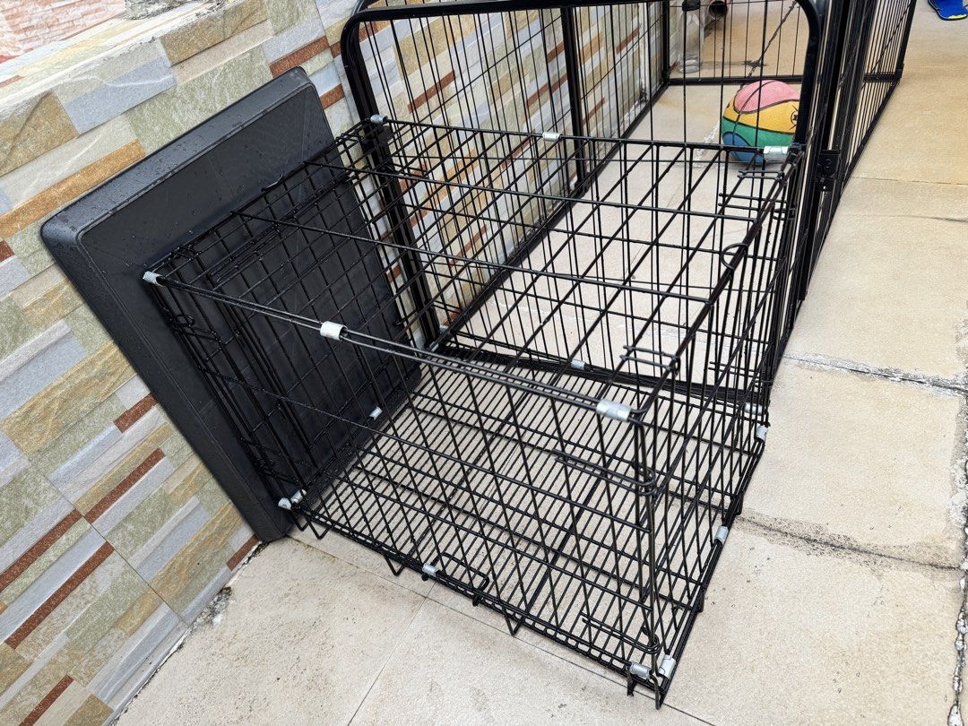 Black wire pet cage with plastic tray (Category: Storage Boxes & Baskets) located in Makati City. Submitted by eeameenelrays (Listing ID 1466136051, Image 1). Description: - Durable heavy-duty black metal wire construction - Includes a dark grey plastic floor tray for easy cleaning - Collapsible design for convenient storage and transport - Secure latches on the front door to keep your pet safe - Ideal size for dogs and puppies - Clean and ready 