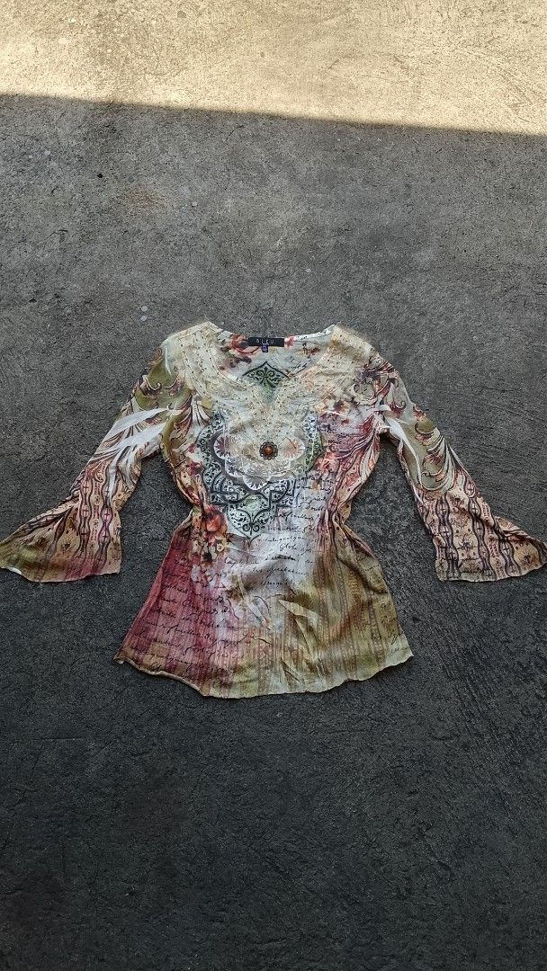 B.L.E.U. Petite Printed Blouse Size PS (Category: Blouses) located in Morong. Submitted by sanjuancla56319 (Listing ID 1465975308, Image 1). Description: - Brand: B.L.E.U. - Size: Petite Small (PS) - Material: 100% polyester - Design: Colorful vintage pattern with script writing and flared sleeves - Neckline: V-neck with embroidery, beadwork, and a central jewel brooch detail - Care Instructions: Hand wash cold, lay flat to dry - Origin: Made in 