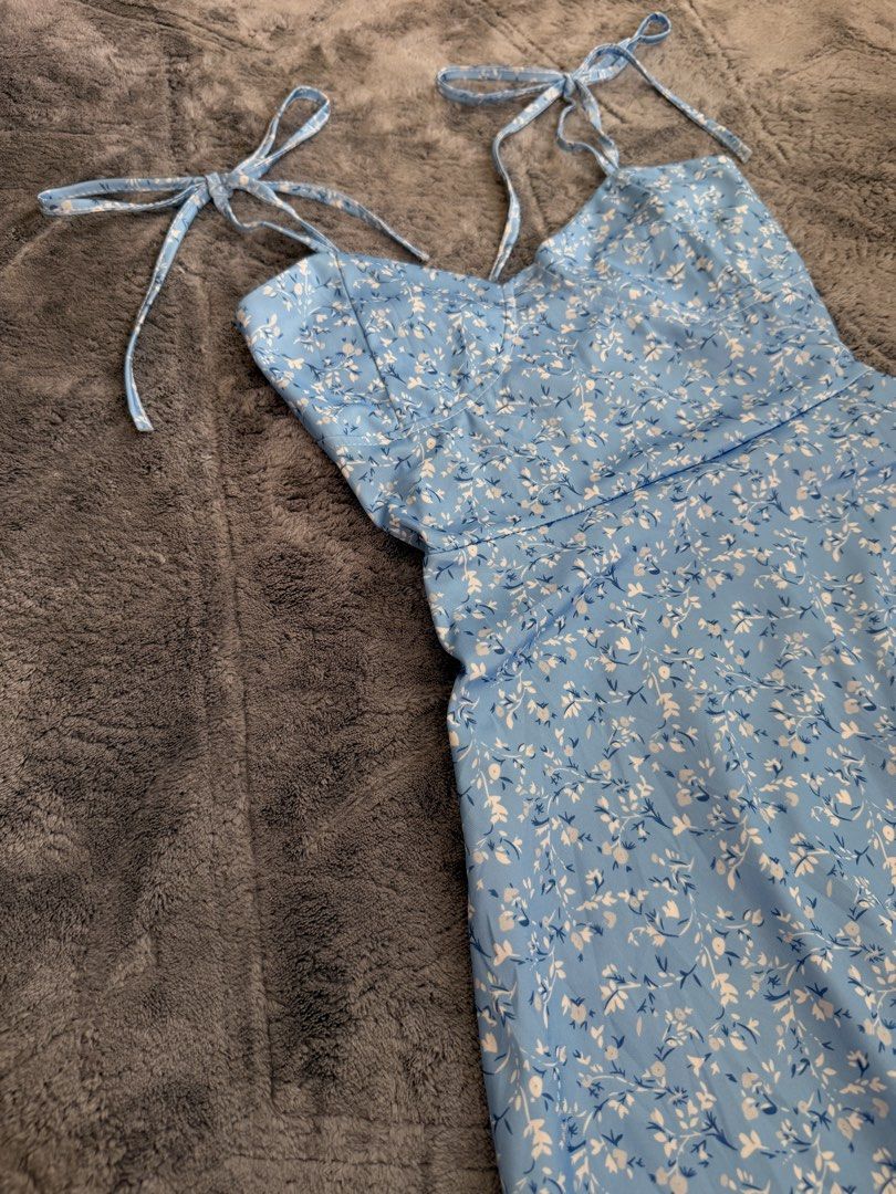 Blue Floral Tie-Strap Mini Dress (Category: Dresses) located in Manila. Submitted by yeti_it (Listing ID 1466058353, Image 2). Description: - Color & Pattern: Light blue with small white flowers - Neckline: Sweetheart neckline with molded cups - Straps: Adjustable tie straps at the shoulders - Fit & Style: A-line flared skirt, short mini length - Closure: Back zipper closure - Perfect for: Summer outings and casual dates.
