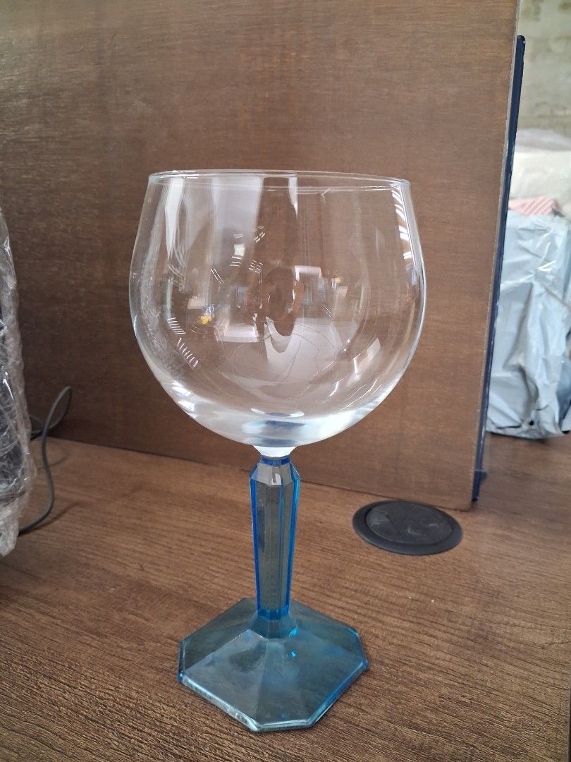 Blue Stemmed Clear Glass Goblet (Category: Dinnerware & Cutlery) located in Taguig. Submitted by ssvcn (Listing ID 1465971983, Image 1). Description: - Stunning clear glass bowl with vibrant blue geometric stem - Sturdy, heavy hexagonal base for great stability - Large capacity design, ideal for wine or cocktails - Impeccable condition: clean with no chips or cracks - Ready for meetup/pickup or shipping.