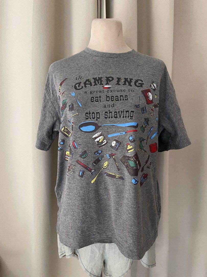 boxy gray funny tee (Category: Shirts) located in Cainta. Submitted by zlove111 (Listing ID 1466113581, Image 1). Description: - Color: Grey - Fit: Relaxed fit, classic crew neck - Material: Comfortable short-sleeve t-shirt - Design: Humorous 'Ah. CAMPING a great excuse to eat beans and stop shaving' text with colorful camping gear illustrations - Condition: Brand new / Excellent quality - Perfect for: Camping trips, outdoor lovers, and casual we