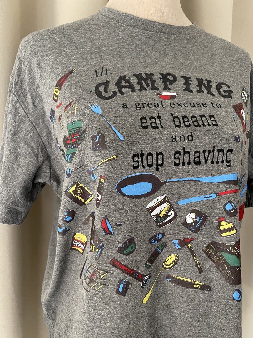 boxy gray funny tee (Category: Shirts) located in Cainta. Submitted by zlove111 (Listing ID 1466113581, Image 2). Description: - Color: Grey - Fit: Relaxed fit, classic crew neck - Material: Comfortable short-sleeve t-shirt - Design: Humorous 'Ah. CAMPING a great excuse to eat beans and stop shaving' text with colorful camping gear illustrations - Condition: Brand new / Excellent quality - Perfect for: Camping trips, outdoor lovers, and casual we
