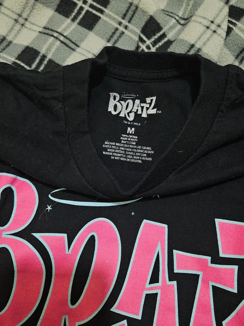 Bratz Black Graphic Print T-Shirt Medium (Category: Shirts) located in General Trias. Submitted by averageukayenjoyer (Listing ID 1466053907, Image 2). Description: - Color: Black with pink and blue Bratz graphic - Size: Medium - Material: 100% cotton (Made in Haiti) - Care: Machine wash cold - Style: Casual Y2K streetwear basic.
