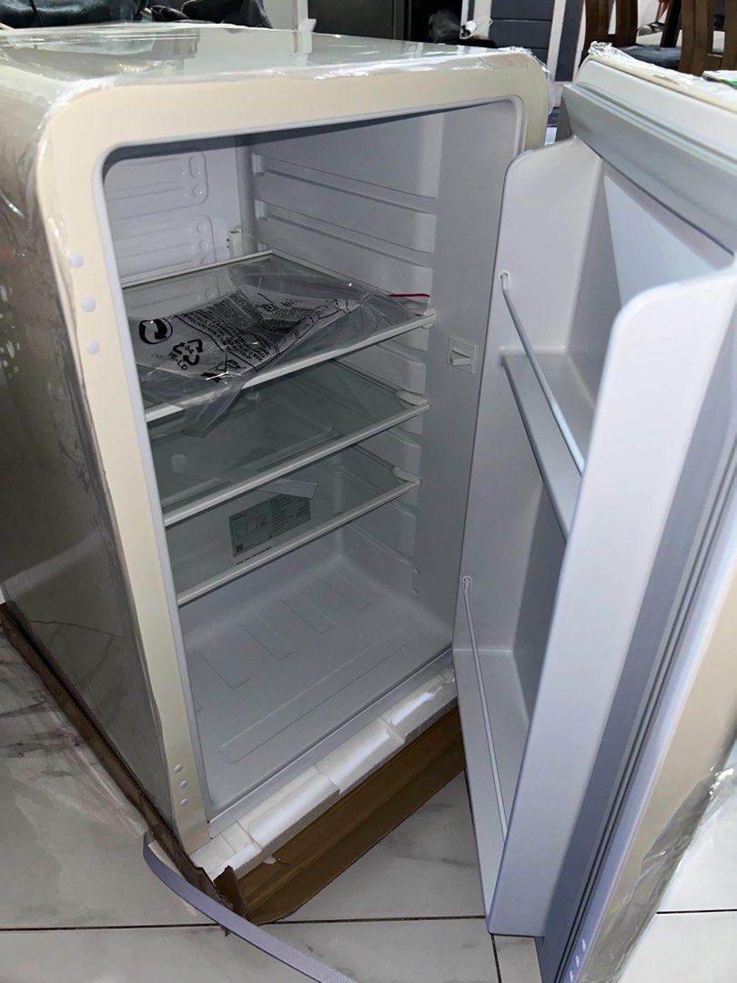 BRIKK Cream Retro Mini Fridge (Category: Refrigerators and Freezers) located in Taguig. Submitted by _nicsss (Listing ID 1466019301, Image 2). Description: - Brand: Brikk - Color: Cream with stylish silver lettering - Style: Retro design with rounded corners - Condition: Brand new, never plugged in or used (still has exterior protective plastic and cardboard base) - Storage: 3 removable glass shelves and convenient door storage racks - Ideal For: