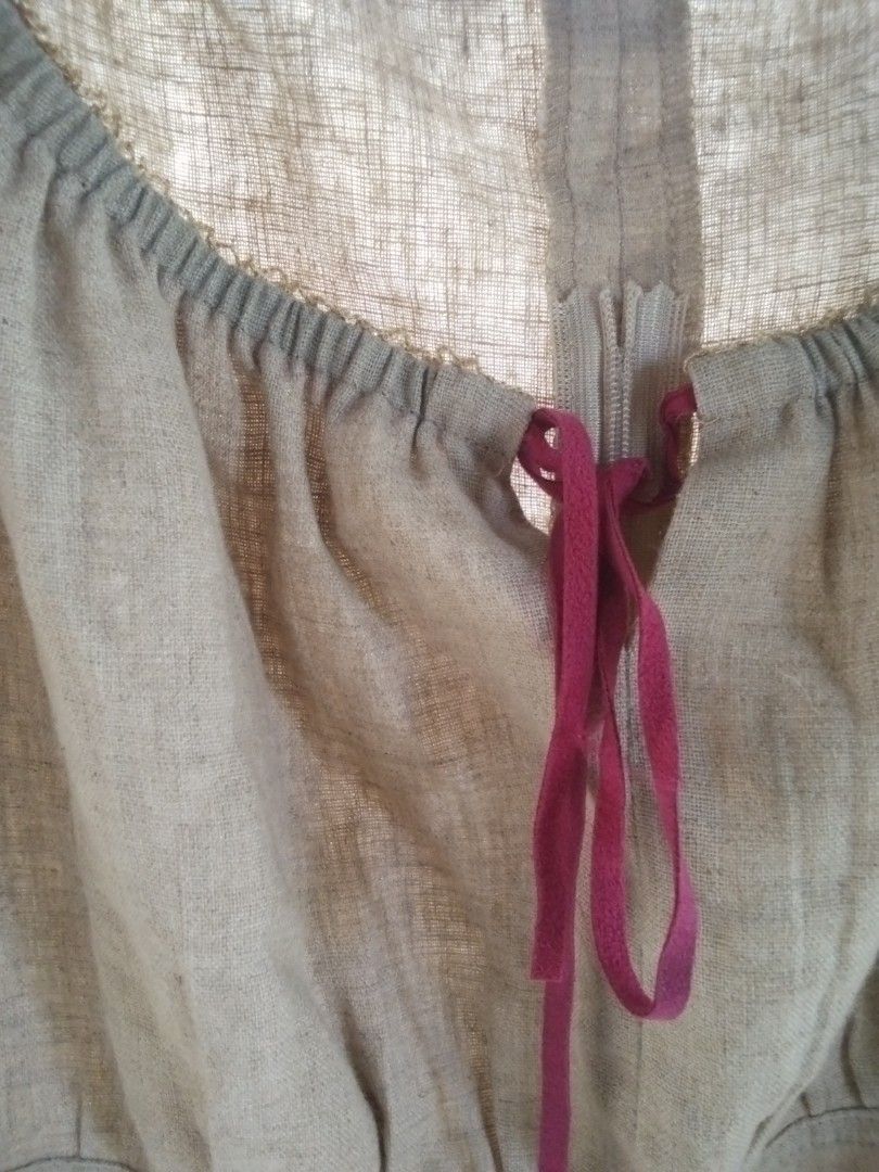 Brown Linen Blouse with Red Ribbon (Category: Blouses) located in Alaminos. Submitted by dangpreloved01 (Listing ID 1465965929, Image 2). Description: - Color: Brown - Material: Lightweight textured linen - Design: Gathered neckline with a deep red ribbon tie - Sleeves: Short sleeves - Closure: Hook-and-eye near the neckline - Condition: Great casual top for warm weather.