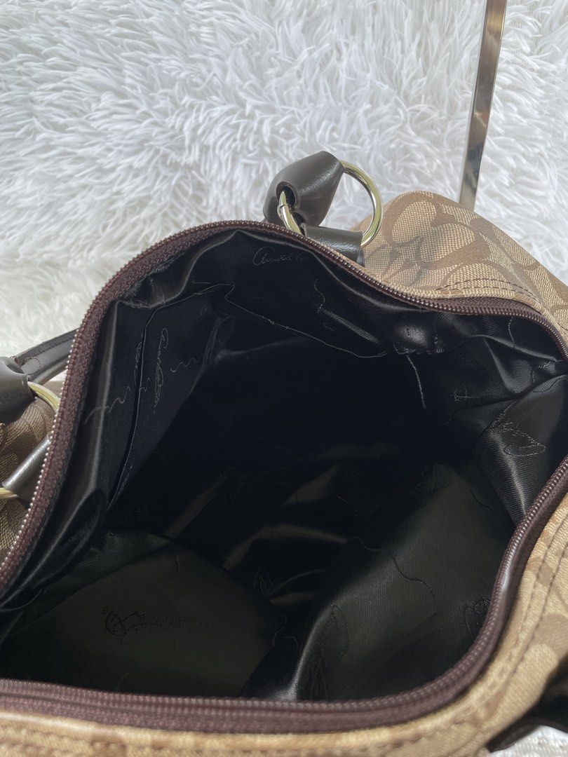 Brown Signature Monogram Pattern Shoulder Bag (Category: Shoulder Bags) located in San Carlos. Submitted by jessamaep_deer (Listing ID 1465993282, Image 3). Description: - Brown canvas monogram shoulder bag - Dark brown leather trim on handles and corners - Exterior zippered pocket on the back - Secure top zipper closure - Dark satin lining with interior slip pockets - Twin grab handles with silver-toned hardware - Spacious interior for daily ess