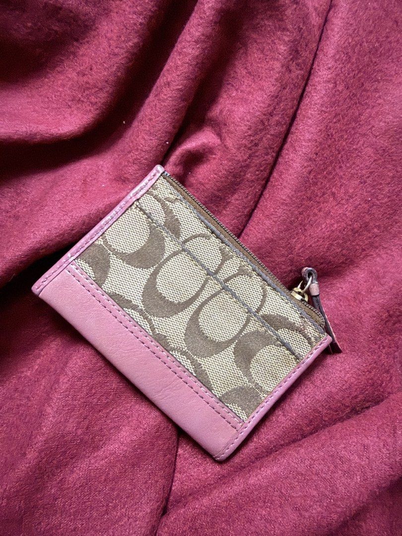 BUNDLE FREE BAG (Category: Luxury Bags & Wallets) located in Manila. Submitted by angelcurated (Listing ID 1465974758, Image 3). Description: - Brand: Coach - Design: Pink signature C canvas with solid pink leather trim - Closure: Top zip closure with pull tab - Interior: Clean pink fabric lining with embossed Coach creed patch - Condition: Clean interior and exterior - Size: Compact, fits easily into smaller bags or pockets.