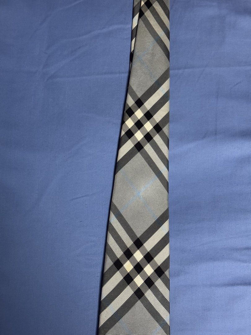 Burberry Black Label Check Silk Tie Grey (Category: Ties) located in Manila. Submitted by seangoart (Listing ID 1466050385, Image 3). Description: - Brand: Burberry Black Label - Design: Classic grey, black, and white plaid check with subtle light blue accent lines - Details: Standard width silhouette with branded fabric tag on the back lining - Lining: Dark navy backing fabric featuring a woven equestrian knight logo pattern near the tip - Condi