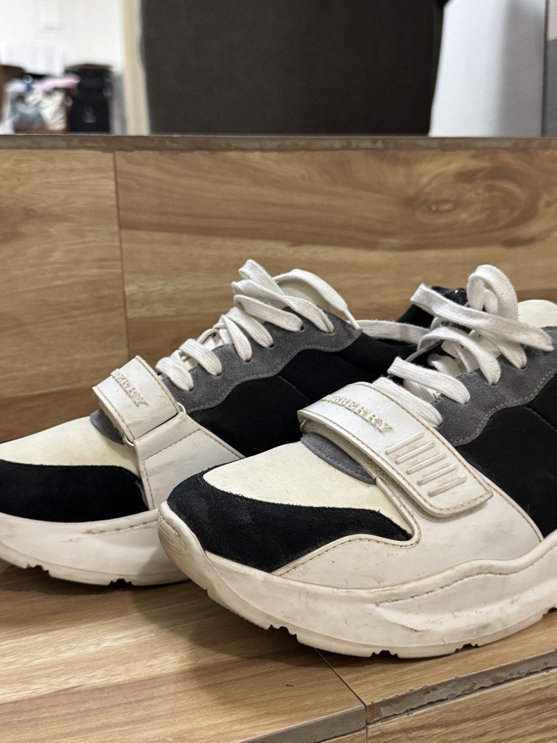 Burberry Chunky Sneakers Black White Grey (Category: Sneakers) located in Balanga. Submitted by dbg13 (Listing ID 1466096922, Image 3). Description: - Brand: Burberry - Style: Chunky streetwear sneakers - Colorway: Black, white, and grey - Details: Lace-up closure with Velcro strap over laces and embossed Burberry lettering - Materials: Grey suede and smooth leather paneling with thick white rubber soles - Condition: Pre-owned with visible wear m