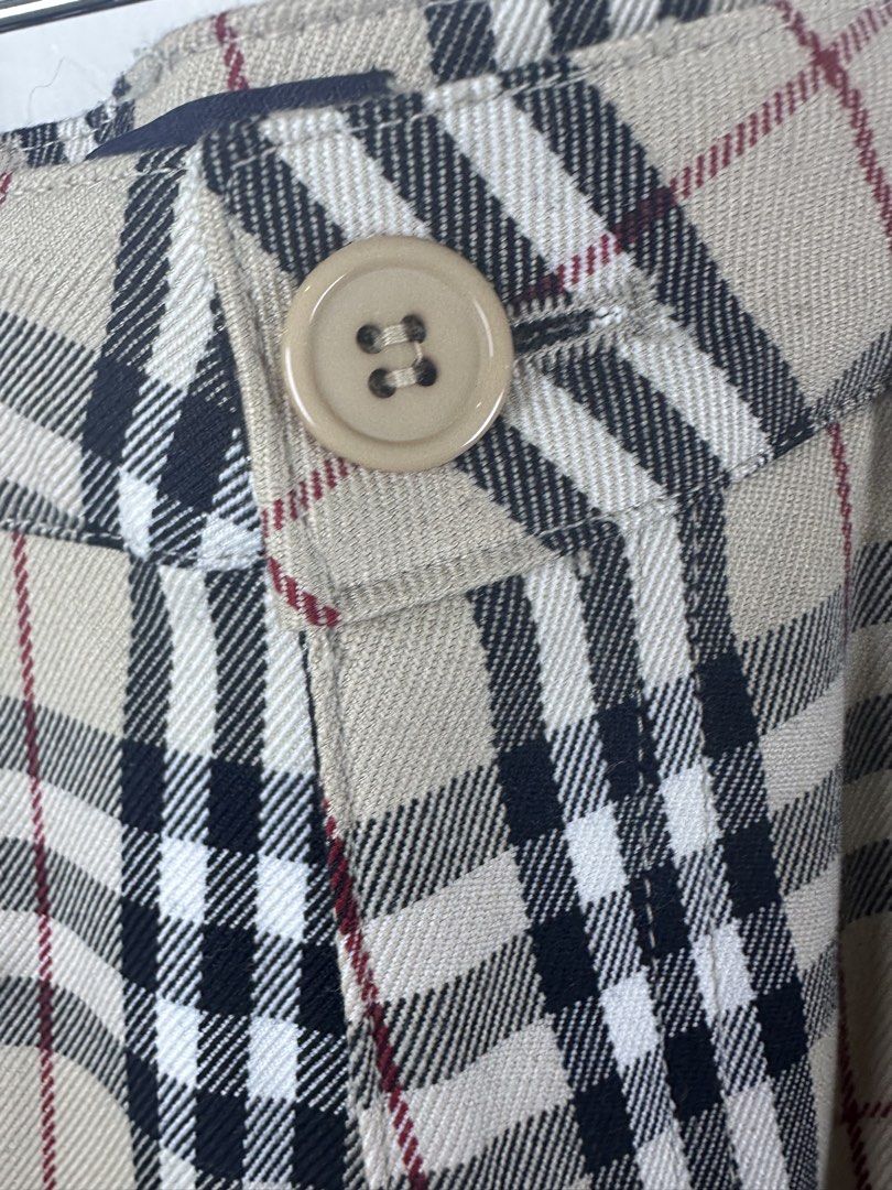 Burberry London Nova Check Flare Pants (Category: Jeans) located in Manila. Submitted by declutterpromax (Listing ID 1466005632, Image 2). Description: - Burberry London flare trousers - Iconic beige nova check pattern throughout - Flattering retro flared leg silhouette - Classic front button closure - Subtle embroidered equestrian knight logo on the back pocket - Tagged size visible in photos - Great designer staple piece for any wardrobe.