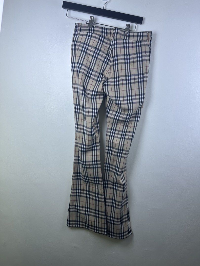 Burberry London Nova Check Flare Pants (Category: Jeans) located in Manila. Submitted by declutterpromax (Listing ID 1466005632, Image 3). Description: - Burberry London flare trousers - Iconic beige nova check pattern throughout - Flattering retro flared leg silhouette - Classic front button closure - Subtle embroidered equestrian knight logo on the back pocket - Tagged size visible in photos - Great designer staple piece for any wardrobe.