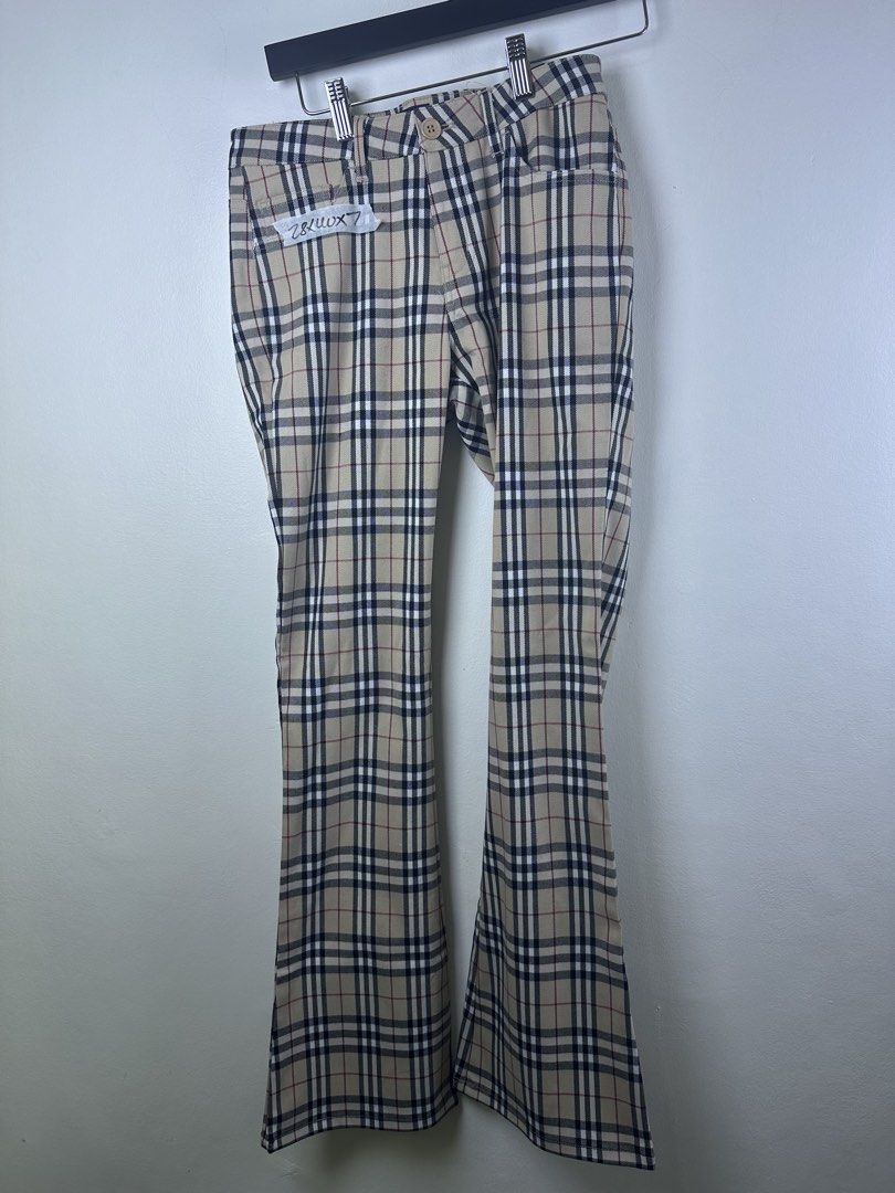 Burberry London Nova Check Flare Pants (Category: Jeans) located in Manila. Submitted by declutterpromax (Listing ID 1466005632, Image 1). Description: - Burberry London flare trousers - Iconic beige nova check pattern throughout - Flattering retro flared leg silhouette - Classic front button closure - Subtle embroidered equestrian knight logo on the back pocket - Tagged size visible in photos - Great designer staple piece for any wardrobe.