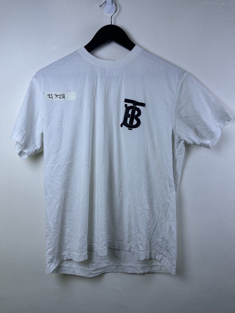 Burberry Monogram TB Logo White T-Shirt (Category: Shirts) located in Manila. Submitted by declutterpromax (Listing ID 1466014884, Image 1). Description: - Burberry TB Monogram T-Shirt - Color: Crisp White with Black Rubber TB Logo Patch - Material: Premium 100% Cotton (Made in Portugal) - Fit: Classic crew neck, short sleeves, regular fit - Details: Includes interior Burberry London England collar tag - Condition: Brand new / Excellent daily cas