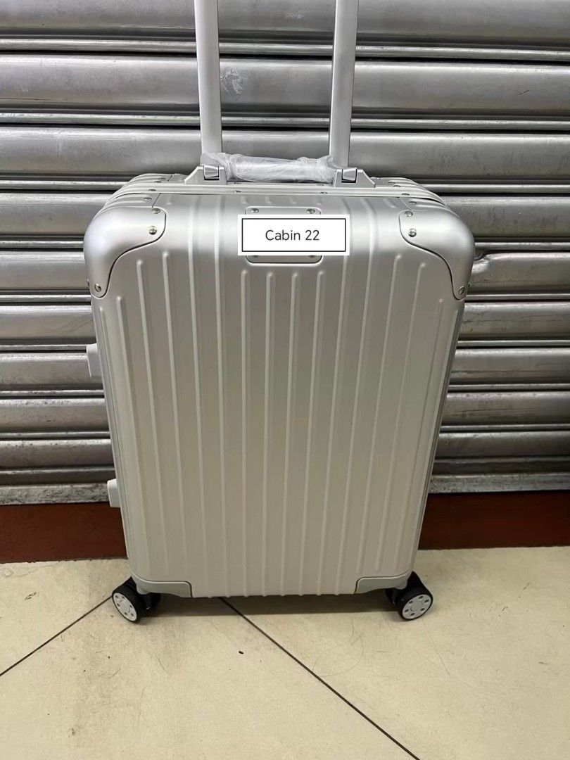 Cabin 22 Aluminum Suitcase (Category: Luggage) located in Manila. Submitted by dh3nz1 (Listing ID 1466154536, Image 3). Description: - Brand: Rimowa Cabin 22 Rolling Luggage - Material: Sturdy aluminum hardshell with iconic vertical grooves - Mobility: Smooth-rolling spinner wheels and adjustable telescopic handle - Protection: Reinforced corners with secure rivet details - Colors Available: Classic Black, Silver, and Gold - Convenience: Cabin-si