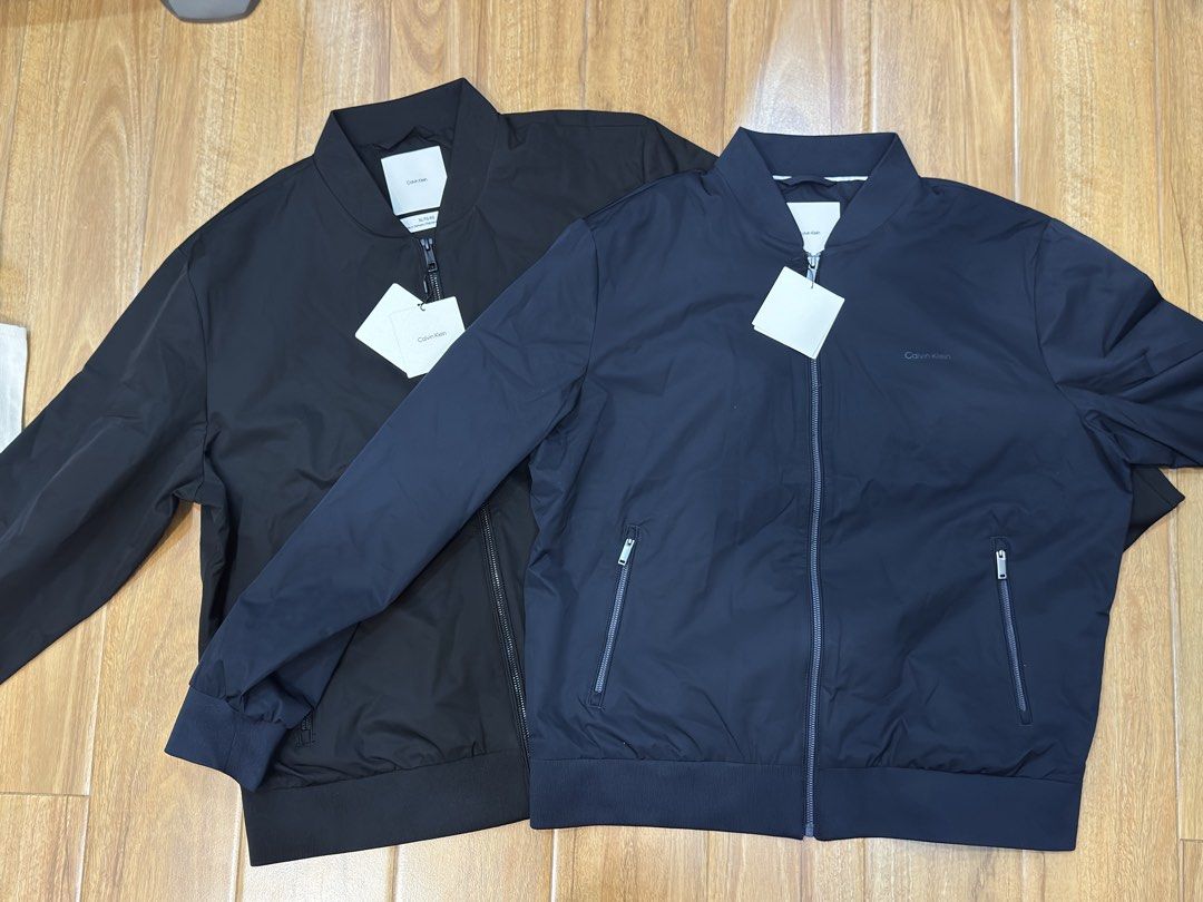 Calvin Klein Bomber Jacket (Category: Coats, Jackets and Outerwear) located in Cavite. Submitted by justblue1921 (Listing ID 1466001976, Image 3). Description: - Brand: Calvin Klein - Style: Zip-up bomber jacket - Color/Design: Clean dark design, easy to match - Size: XL,L - Details: Ribbed collar and cuffs, subtle tonal embroidered logo on chest - Closure: Full front zipper with metallic pull - Condition: Brand new from US 🇺🇸.