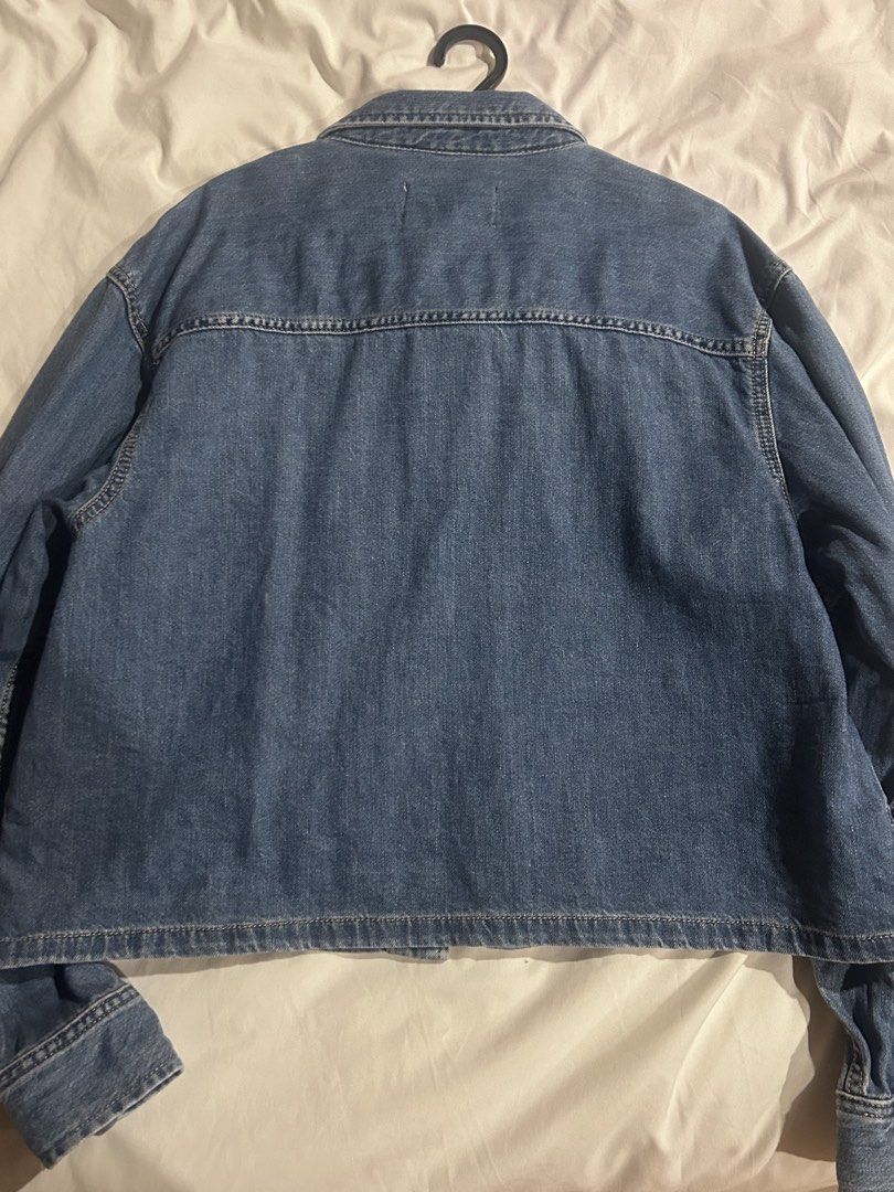 Calvin Klein Jeans Denim Jacket (Category: Coats, Jackets and Outerwear) located in Cebu City. Submitted by shopmikascloset (Listing ID 1466055269, Image 2). Description: Barely worn Brand: Calvin Klein Jeans - Wash: Medium wash denim - Details: Classic button-up front with metallic hardware, structured collar, and clean back yoke - Pockets: Two chest flap pockets (one with signature logo patch) - Sleeves: Long sleeves with buttoned cuffs - Fit/S