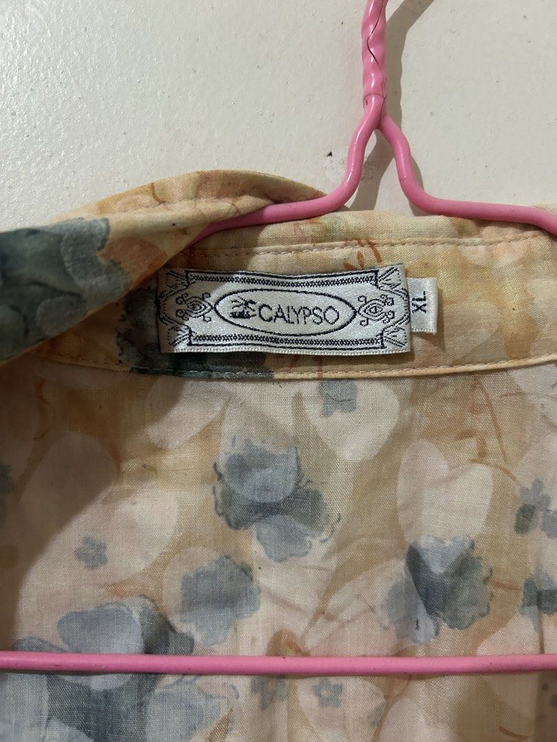 Calypso Floral Short-sleeved Blouse (Category: Blouses) located in Naga. Submitted by aroaldaw (Listing ID 1466002886, Image 2). Description: This peach floral short-sleeve button-up blouse features a classic collar and a lightweight, sheer fabric design. Can fit M-L.