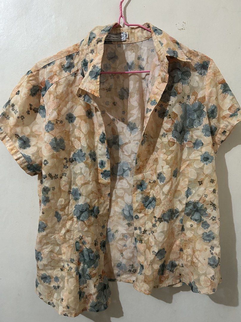Calypso Floral Short-sleeved Blouse (Category: Blouses) located in Naga. Submitted by aroaldaw (Listing ID 1466002886, Image 1). Description: This peach floral short-sleeve button-up blouse features a classic collar and a lightweight, sheer fabric design. Can fit M-L.