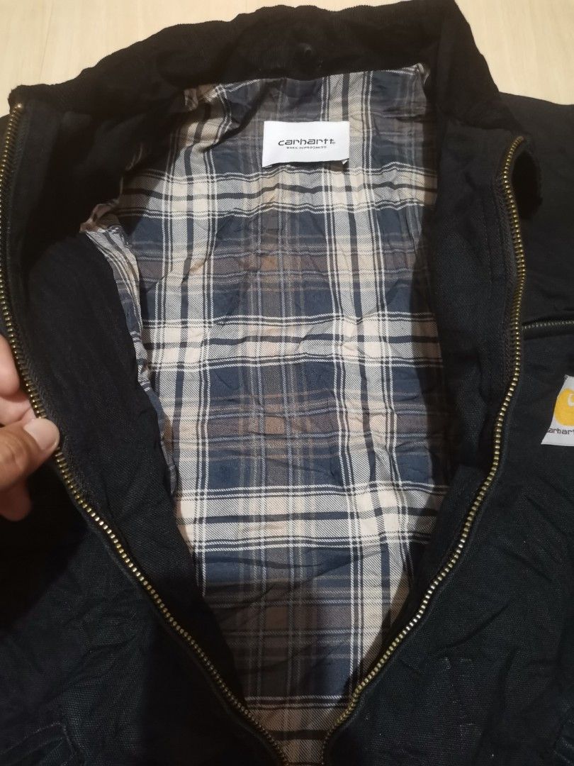 Carhartt Work in Progress Black Detroit Jacket (Category: Coats, Jackets and Outerwear) located in Tacloban City. Submitted by azthrifting24 (Listing ID 1465983166, Image 3). Description: - Brand: Carhartt Work in Progress (WIP) - Color: Black canvas with blue and grey flannel lining - Details: Classic corduroy collar, metal zip closure with workwear pull tab - Pockets: Zipped chest pocket with white logo patch, plus two slanted hand pockets - Cu