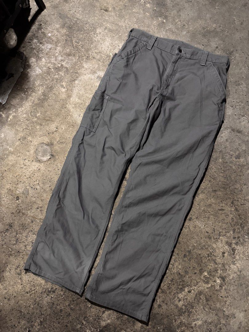 Carhartt Work Pants Grey Cargo Utility Trousers (Category: Jeans) located in Pasig City. Submitted by dripthrift1600 (Listing ID 1466101356, Image 1). Description: - Authentic Carhartt utility work pants in versatile charcoal grey - Built tough with heavy-duty, durable cotton canvas material - Features multiple side tool pockets, a left-leg hammer loop, and reinforced back pockets - Designed with a classic straight leg fit and extra-durable tripl