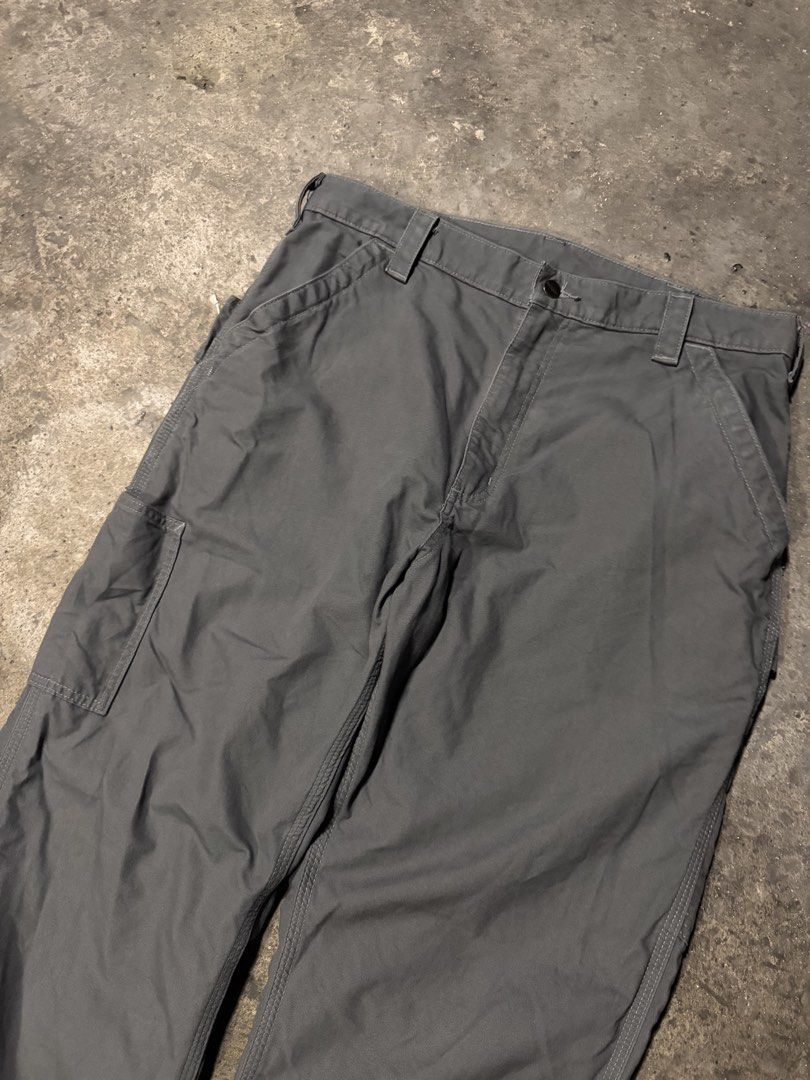 Carhartt Work Pants Grey Cargo Utility Trousers (Category: Jeans) located in Pasig City. Submitted by dripthrift1600 (Listing ID 1466101356, Image 3). Description: - Authentic Carhartt utility work pants in versatile charcoal grey - Built tough with heavy-duty, durable cotton canvas material - Features multiple side tool pockets, a left-leg hammer loop, and reinforced back pockets - Designed with a classic straight leg fit and extra-durable tripl