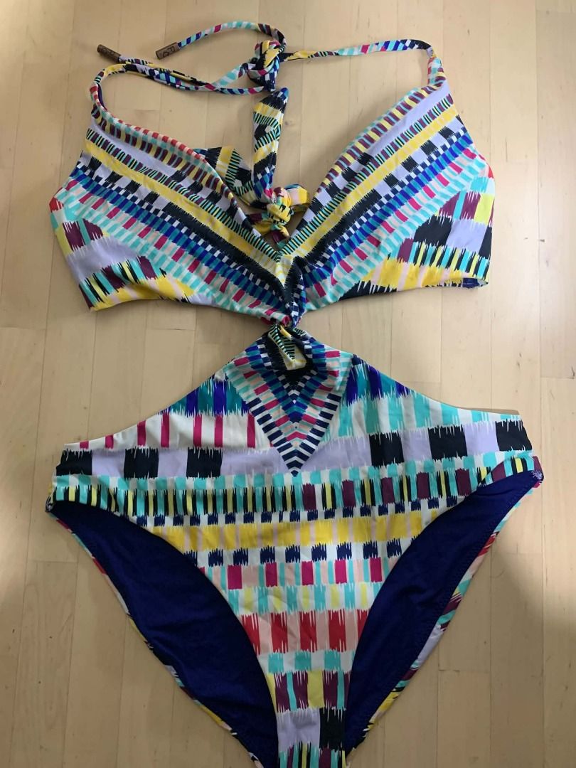 Carter Red Multicolored Ikat Pattern Swimwear | Medium to Large (Category: Bikinis & Swimsuits) located in Manila. Submitted by musedeclutters (Listing ID 1466023183, Image 1). Description: - Brand/Style: Carter Red swimwear piece - Pattern: Vibrant multicolored ikat with vertical stripes in pink, yellow, teal, and navy - Hardware: Bronze-toned metal tips on drawstrings with engraved branding - Details: Unique round red button featuring engraved 