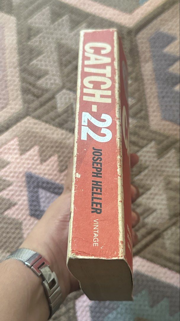 Catch-22 by Joseph Heller 50th Anniversary Edition (Category: Storybooks) located in Manila. Submitted by goldschlagered (Listing ID 1465962905, Image 2). Description: - Title: Catch-22 by Joseph Heller - Edition: 50th Anniversary Vintage Edition (Paperback) - ISBN: 978-0-099-52912-5 - Condition: Pre-loved with vintage charm. Pages have natural yellowing from age; cover has light edge wear - Binding: Solid and intact, perfect for reading. Price n