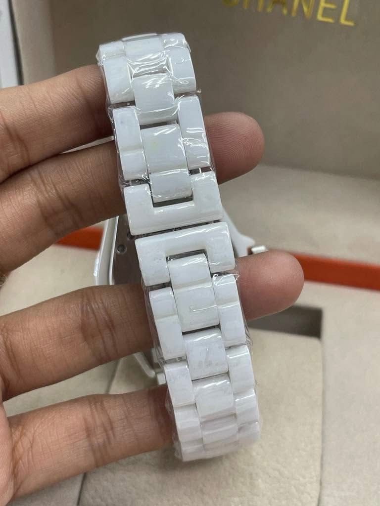 CC J12 White Ceramic Watch (Category: Luxury Watches) located in Manila. Submitted by bagsandmanymanymore1 (Listing ID 1465964010, Image 3). Description: - Brand: CC Watch J12 -Size 40mm - Material: High-tech white ceramic with stainless steel deployment clasp (marked Swiss Made) - Dial: Classic round face with easy-to-read Arabic numerals and rotating bezel - Condition: Pristine, protective plastic wrap still intact on the ceramic bracelet links