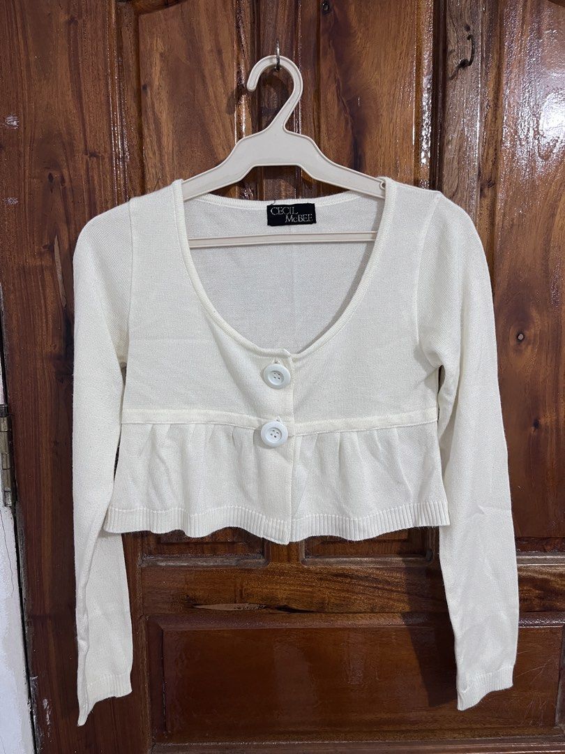 Cecil McBee White Crop Cardigan (Category: Coats, Jackets and Outerwear) located in Baguio. Submitted by gbwardrobe (Listing ID 1466095215, Image 1). Description: - Brand: Cecil McBee - Style: White cropped cardigan with a gathered peplum hem - Details: Scoop neckline, long sleeves, and two large front buttons - Material: Lightweight knit with ribbed cuffs and hem - Fit & Use: Perfect layering piece for casual or dressed-up outfits.