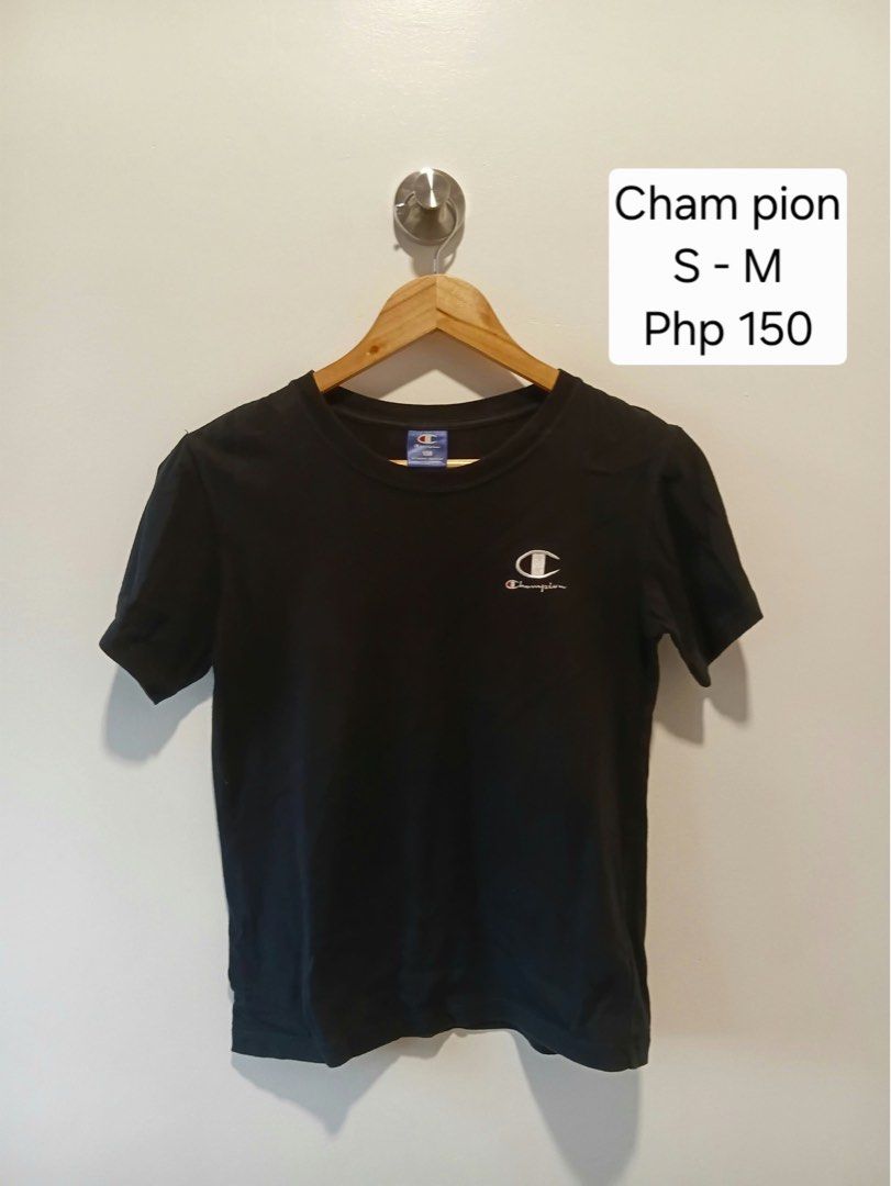 Champion Black T-Shirt Size 150 (Category: Shirts) located in Antipolo. Submitted by wisecat.4a7eea (Listing ID 1466043371, Image 1). Description: - Brand: Champion - Size: 150 (Authentic American athletic apparel) - Color: Black - Design: Classic crew neck with short sleeves - Details: Small white embroidered logo on chest and iconic 'C' patch on left sleeve - Style: Simple, versatile, and easy to mix and match for casual everyday wear.