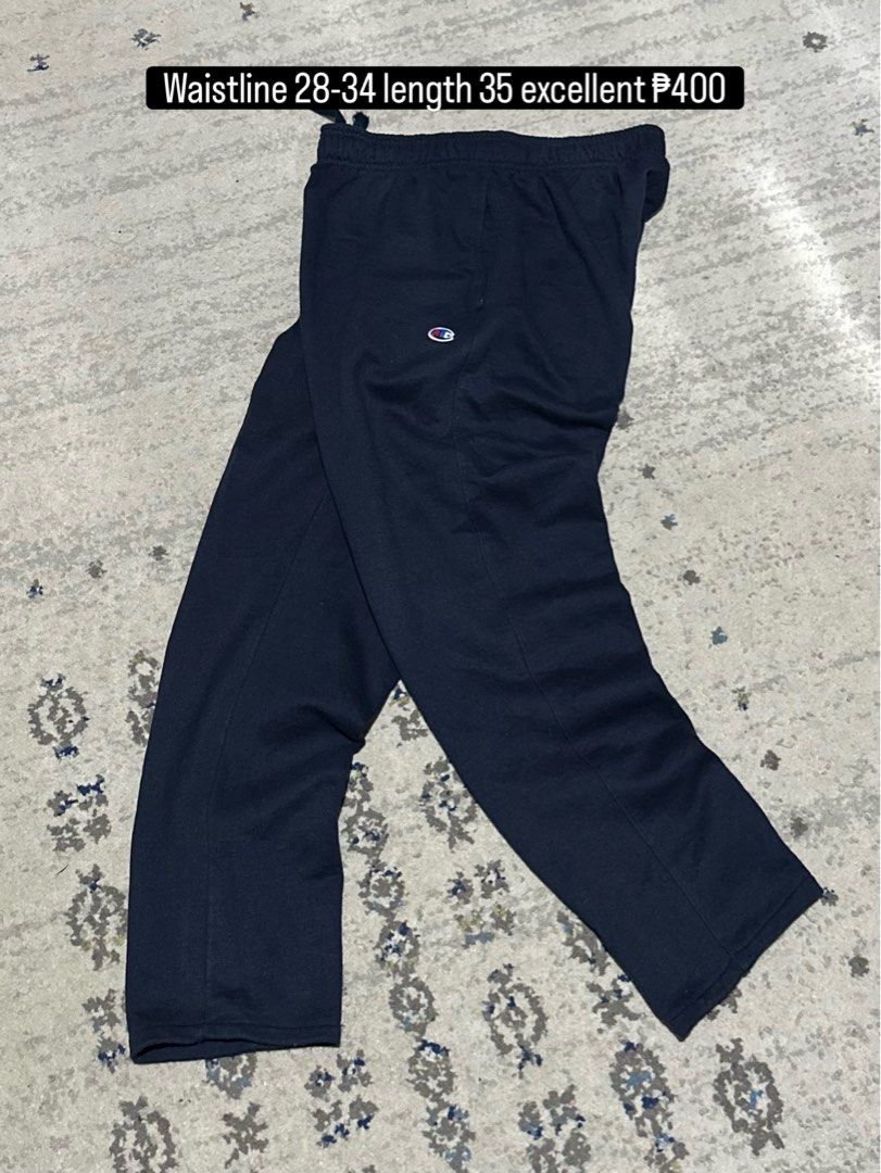 Champion Navy Blue Sweatpants Joggers (Category: Joggers) located in Daet. Submitted by thrifthings2018 (Listing ID 1466056931, Image 1). Description: - Brand: Champion - Color: Classic navy blue - Material: Soft and comfortable cotton blend - Fit: Straight leg with adjustable elastic drawstring waistband (fits waist 28 to 34 inches) - Length: 35 inches - Features: Iconic embroidered Champion logo patch on the left leg and convenient side pockets