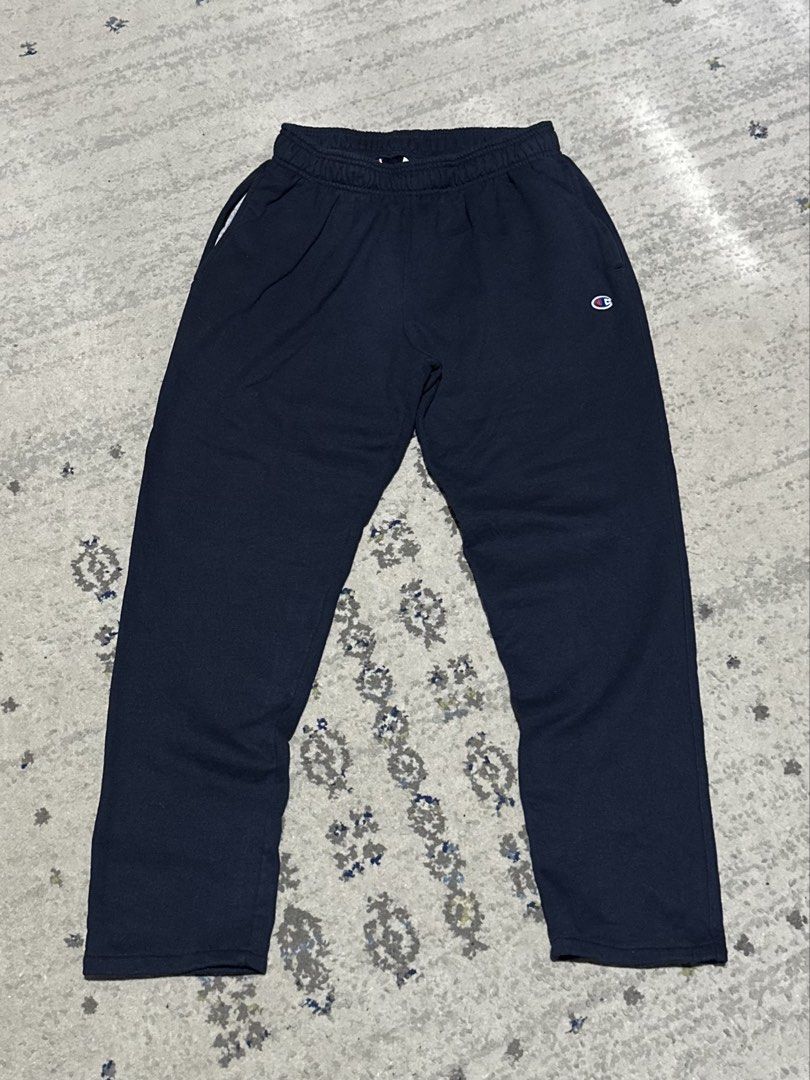 Champion Navy Blue Sweatpants Joggers (Category: Joggers) located in Daet. Submitted by thrifthings2018 (Listing ID 1466056931, Image 2). Description: - Brand: Champion - Color: Classic navy blue - Material: Soft and comfortable cotton blend - Fit: Straight leg with adjustable elastic drawstring waistband (fits waist 28 to 34 inches) - Length: 35 inches - Features: Iconic embroidered Champion logo patch on the left leg and convenient side pockets