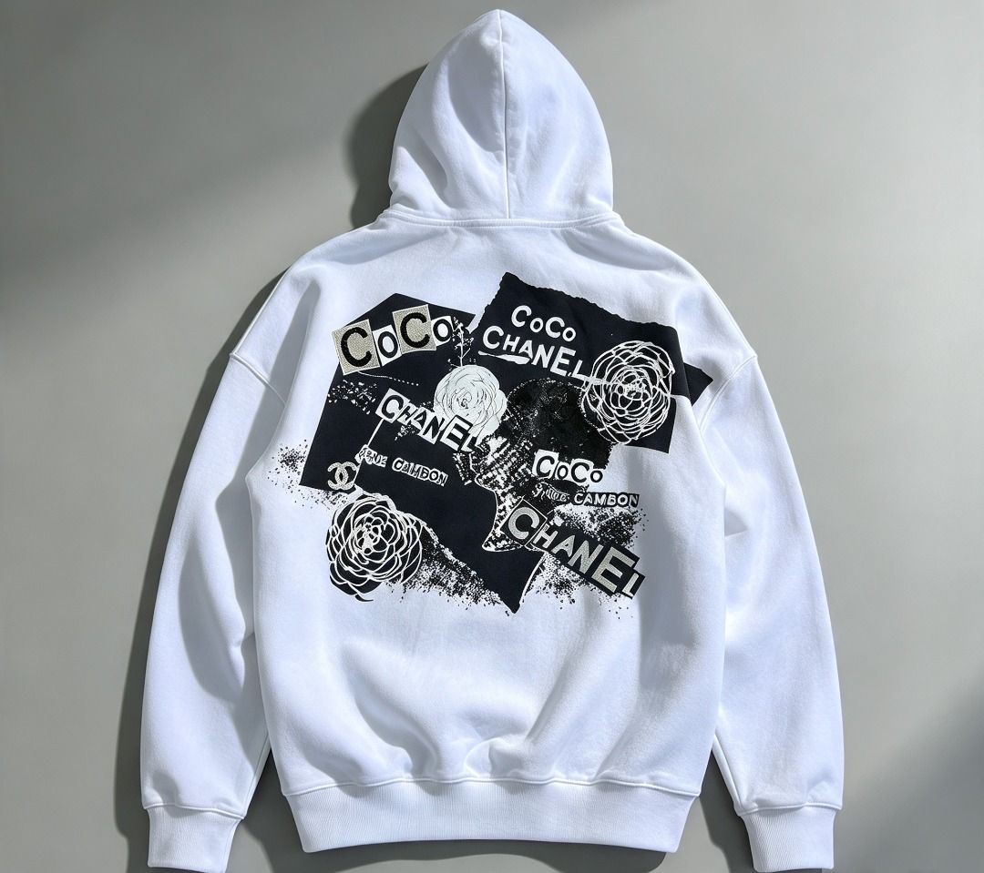Chanel cambon zip up hoodie (Category: Hoodies) located in Caloocan City. Submitted by allen_09191996 (Listing ID 1465964794, Image 1). Description: - Color: White with striking black graphic collage on the back - Design: Features Chanel branding, camellia motifs, and Coco lettering - Size: M (tagged at collar) - Material: Soft, comfortable cotton-blend fabric with a clean finish - Hardware: Silver-tone throughout, including a branded zip pull an
