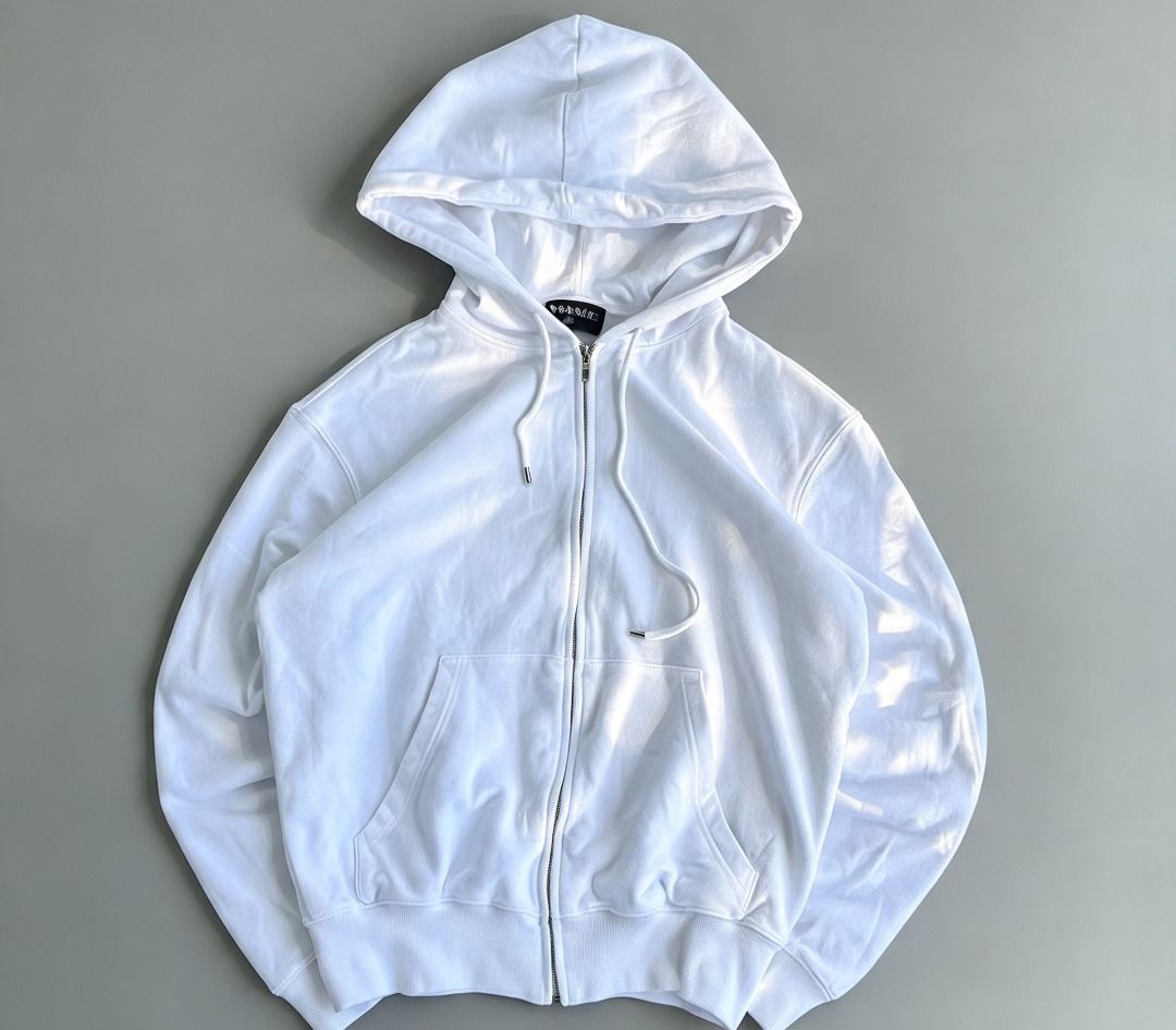 Chanel cambon zip up hoodie (Category: Hoodies) located in Caloocan City. Submitted by allen_09191996 (Listing ID 1465964794, Image 2). Description: - Color: White with striking black graphic collage on the back - Design: Features Chanel branding, camellia motifs, and Coco lettering - Size: M (tagged at collar) - Material: Soft, comfortable cotton-blend fabric with a clean finish - Hardware: Silver-tone throughout, including a branded zip pull an