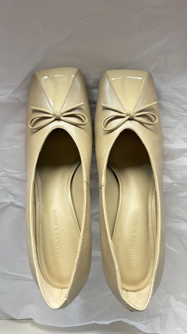 Charles & Keith Beige heels with bow detail (Category: Heels) located in Makati City. Submitted by savvy_girl (Listing ID 1466017725, Image 1). Description: - Condition: Brand new with shoe bag - Color: Versatile neutral beige - Design: Modern square toe with a dainty front bow accent - Heel: Comfortable mid-height kitten heel - Fit: Easy slip-on style - Styling: Perfect for office wear, meetings, or casual day-outs RFS: Was a gift but is too big