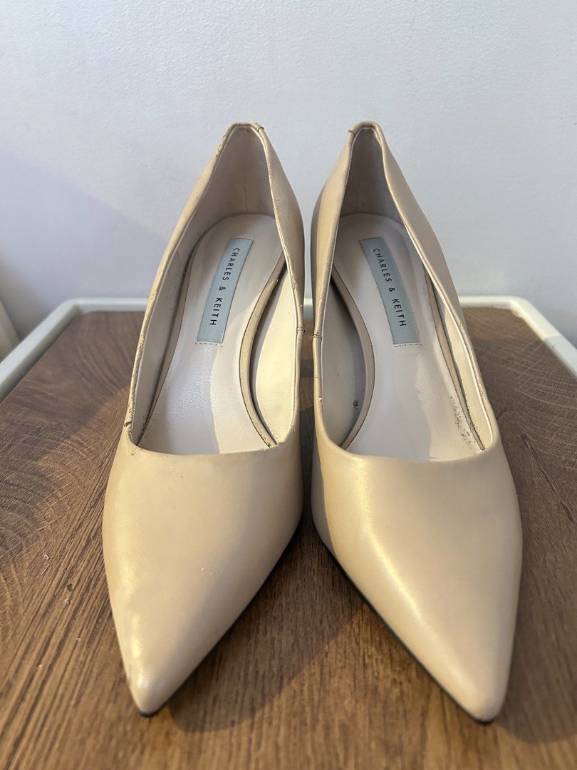Charles & Keith Nude Pointed Toe Heels Size 37 (Category: Heels) located in Taguig. Submitted by fastflower.02faa3 (Listing ID 1466084883, Image 1). Description: - Brand/Model: Charles & Keith Nude Heels - Size: 37 / 235 (fits true to size) - Design: Slip-on, pointed toe, elegant neutral color - Heel: Unique gold metallic block heel (great height for work or events) - Condition: Sturdy overall with some wear inside near the lining and minor scuff