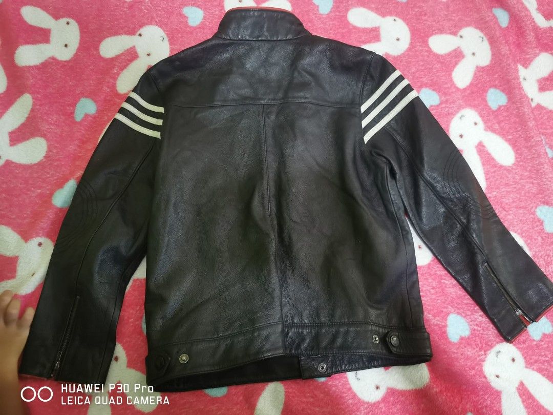 Chickeeduck Leather Jacket, 9 to 10 years old (Category: Coats, Jackets and Outerwear) located in Makati City. Submitted by relianzmae57131 (Listing ID 1466032931, Image 2). Description: - Material: black leather (built to last) - Design: Classic 3 white stripes on shoulders - Accents: Eye-catching red trim on high collar and cuffs - Pockets: Front zipper closure with 2 zipped chest pockets - Fit/Cuffs: Adjustable bottom hem snaps and wrist zippe